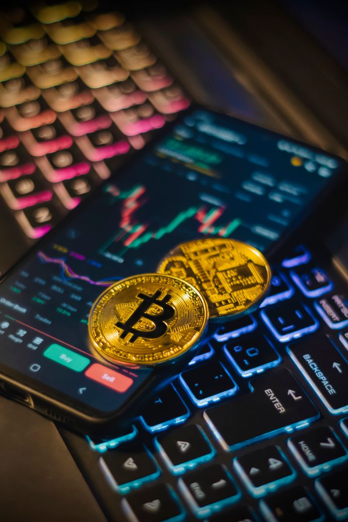 services-03 Colorful keyboard with Bitcoin coins and trading screen for crypto analysis.